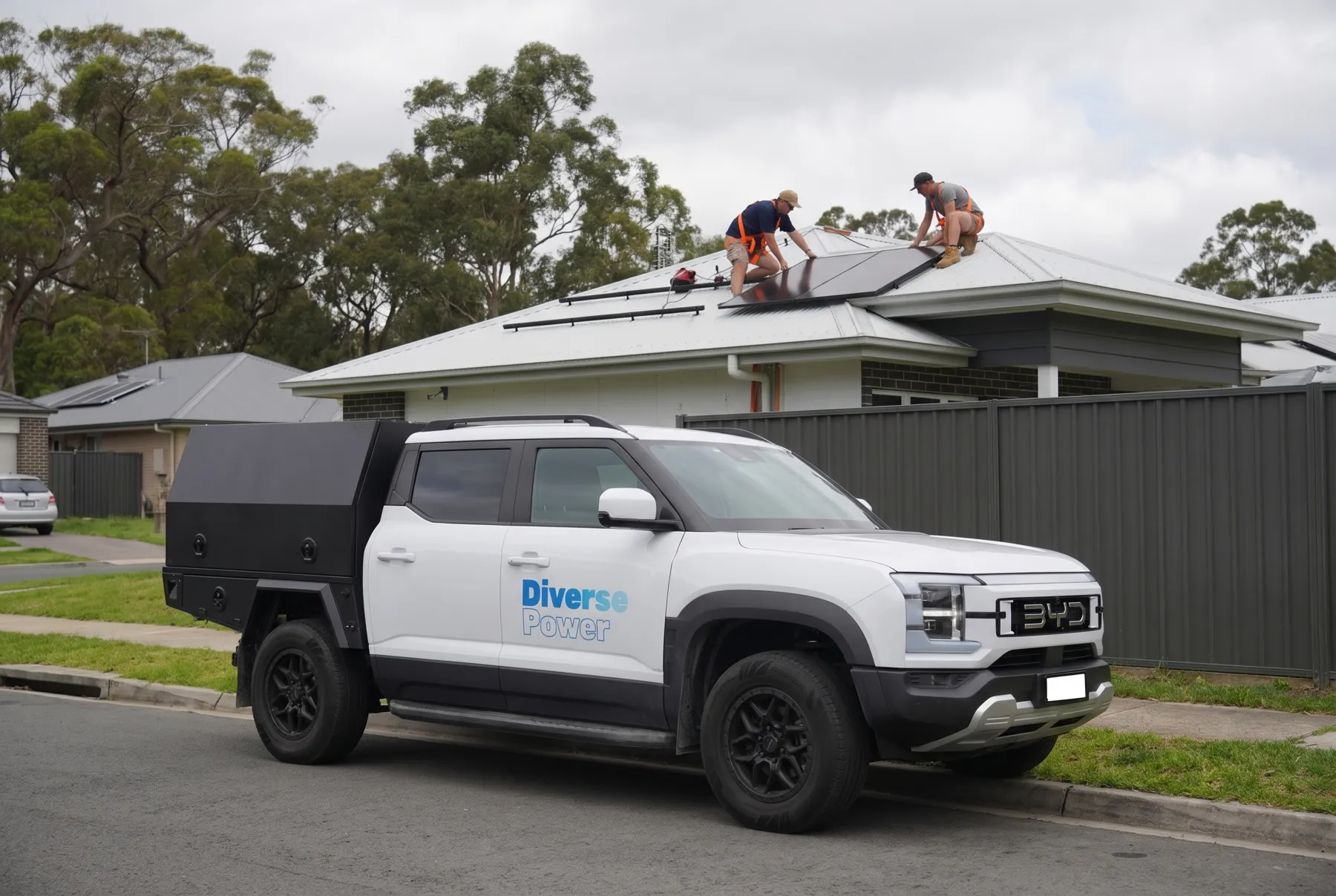 The Diverse Power ute outside a home with crew on the roof